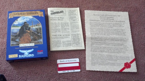 An image showing the Guild of Theives game box, a small manual set up as a newspaper, a contract hiring the player and a fake bank card.